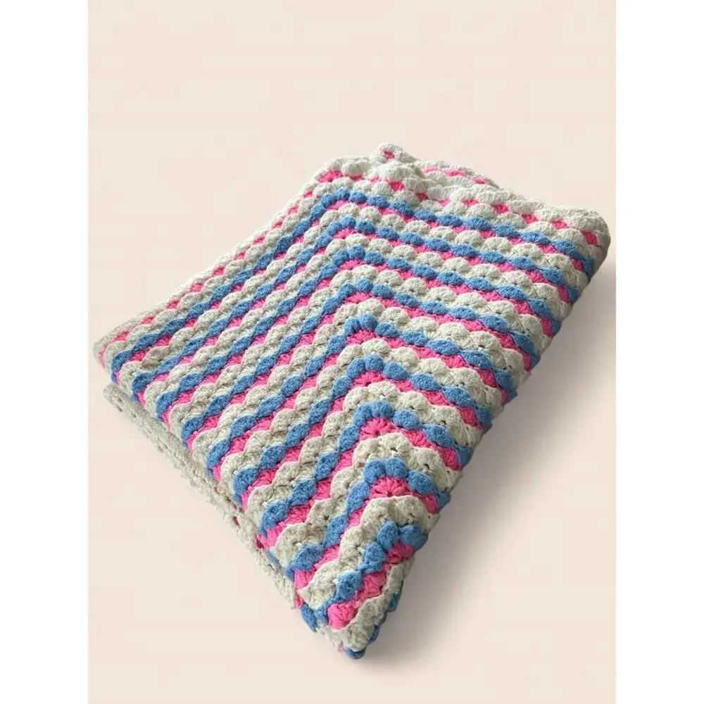 Oversized vintage handmade crochet afghan blanket in pink, blue and cream